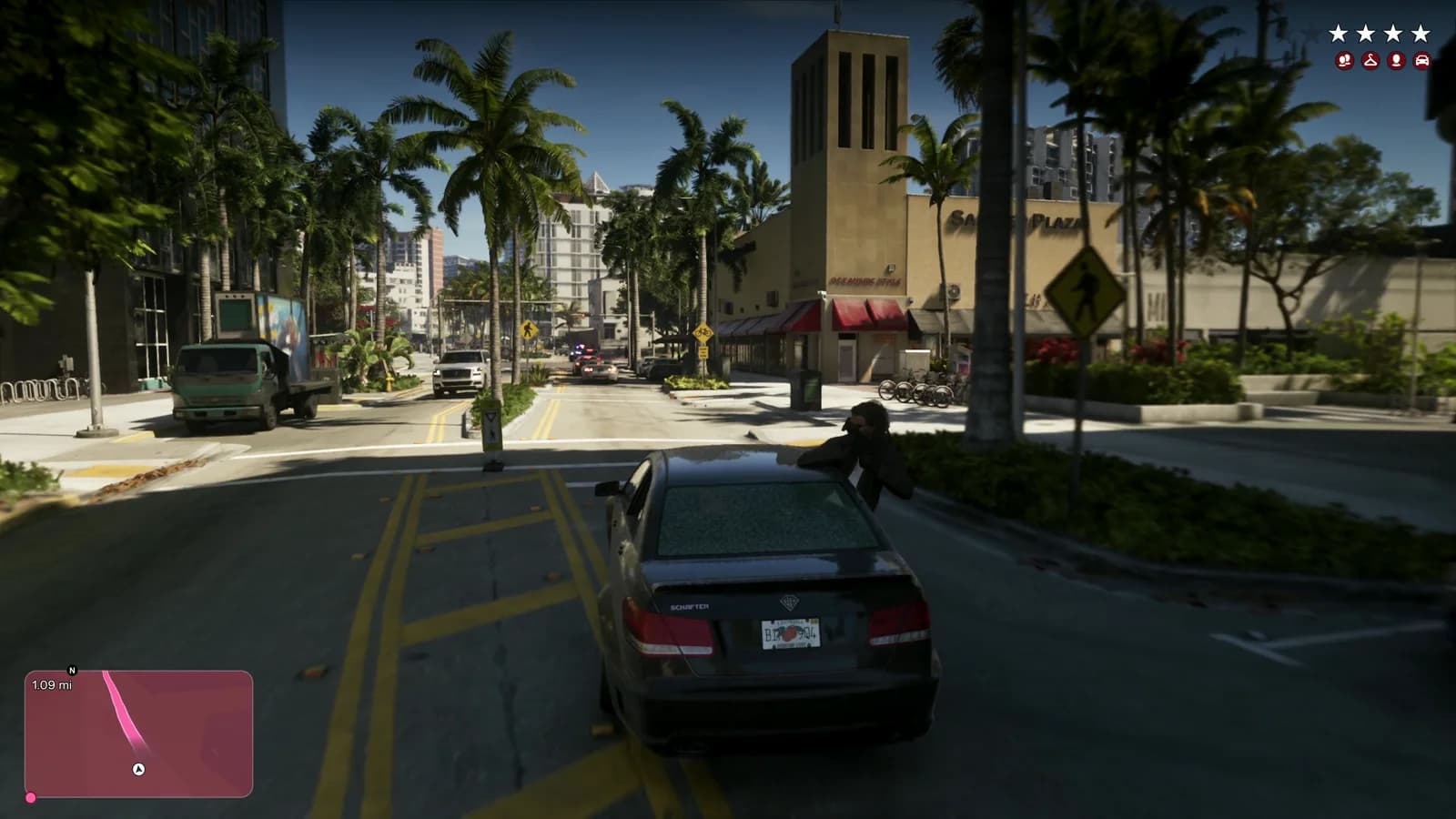 L'auto Schafter prosegue la fuga per una strada alberata; sullo sfondo un edificio con insegna che termina in 'PLAZA' e la scritta 'OCEANSIDE STYLE' su un'altra facciata.